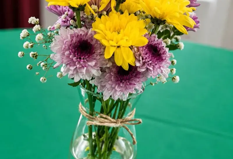 Custom fresh floral arrangement in a vase with branded card