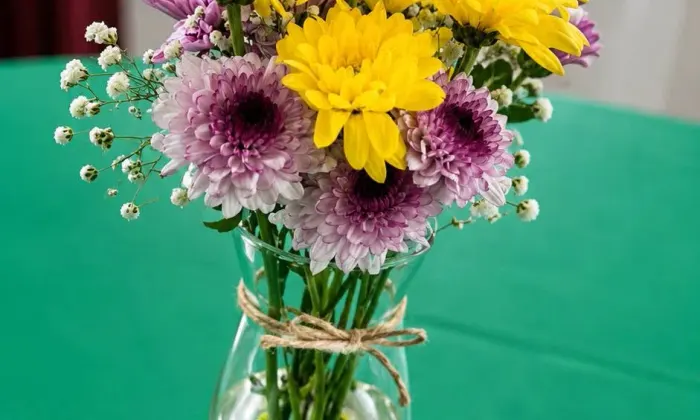 Custom fresh floral arrangement in a vase with branded card