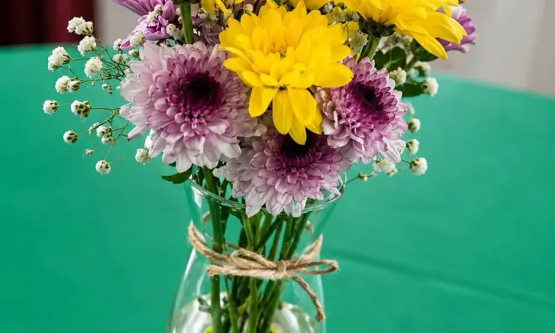 Custom fresh floral arrangement in a vase with branded card